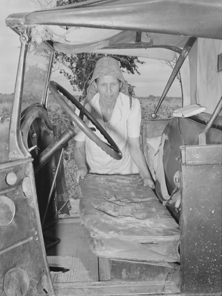 Mrs, Elmer Thomas, Migrant To California, Putting The Front Seat Of Their Truck In Place Preparatory To Departure