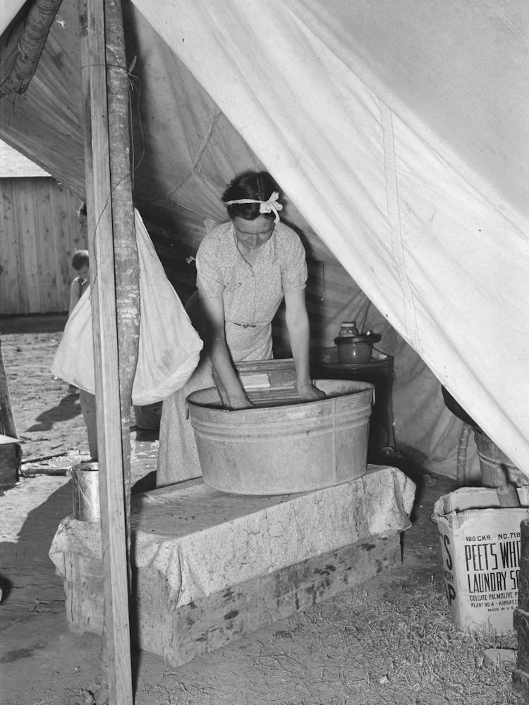 Migrant White Mother Washing Clothes In Front Of Tent Home, Weslaco, Texas, See General Caption By Russell Lee