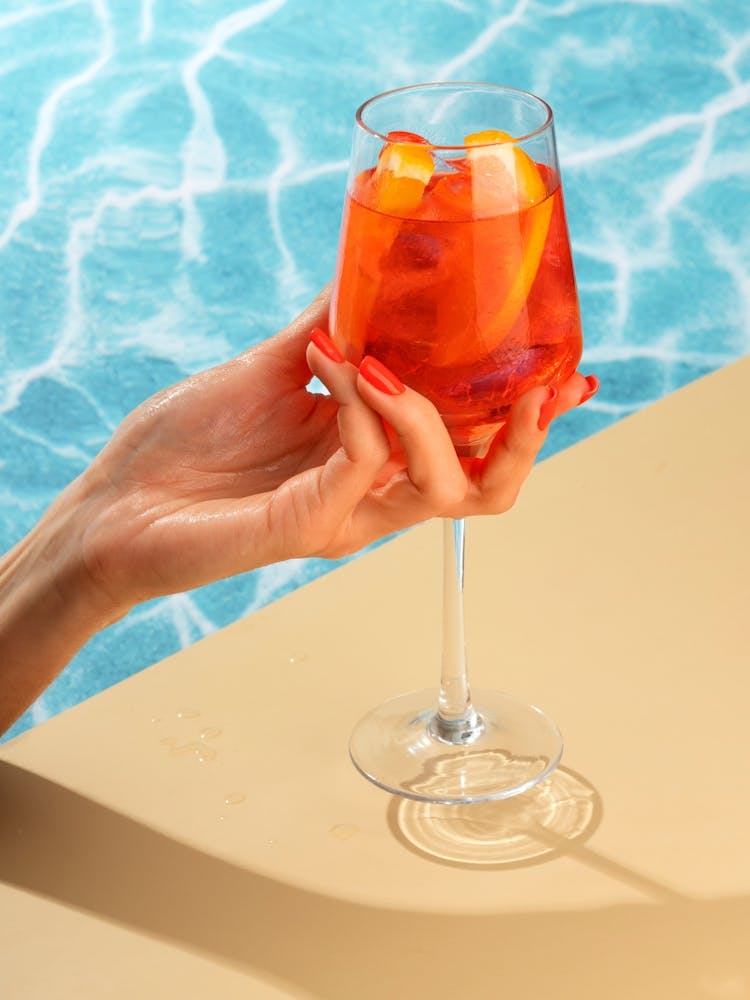 Woman Holding A Glass Of Aperol Spritz