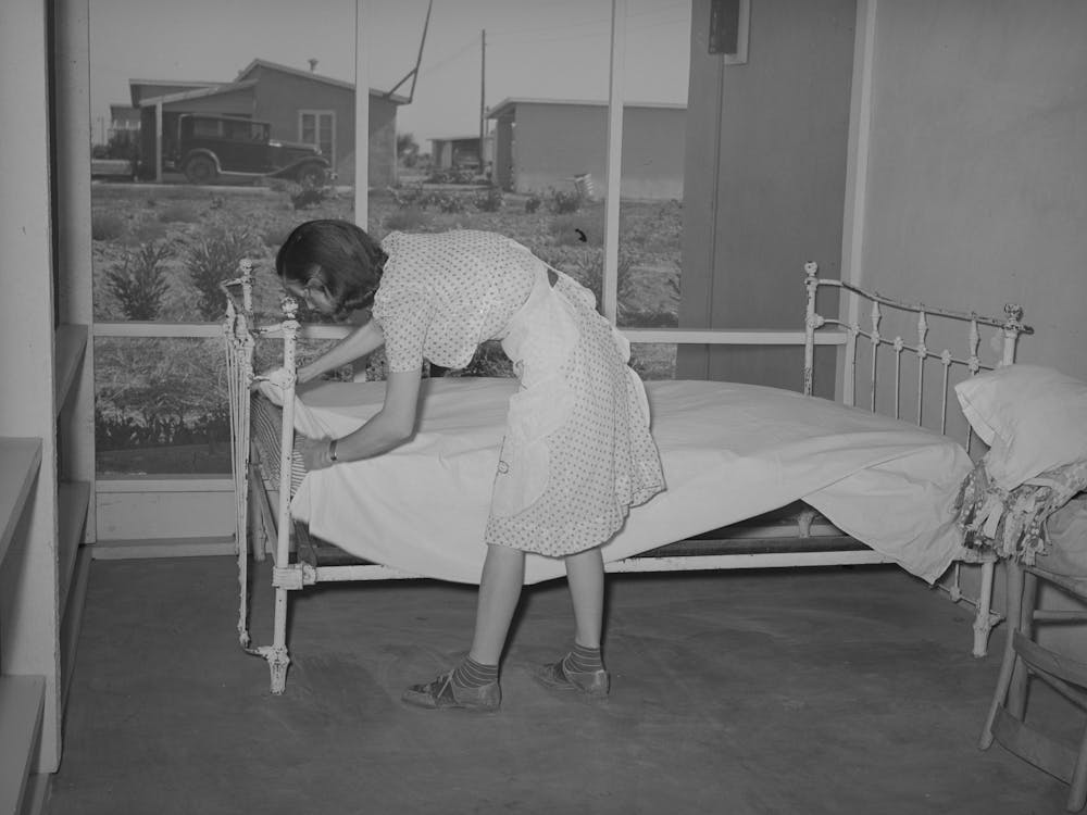 Wife Of Member Of The Casa Grande Valley Farms, Pinal County, Arizona Making Up Bed On Her Porch, These