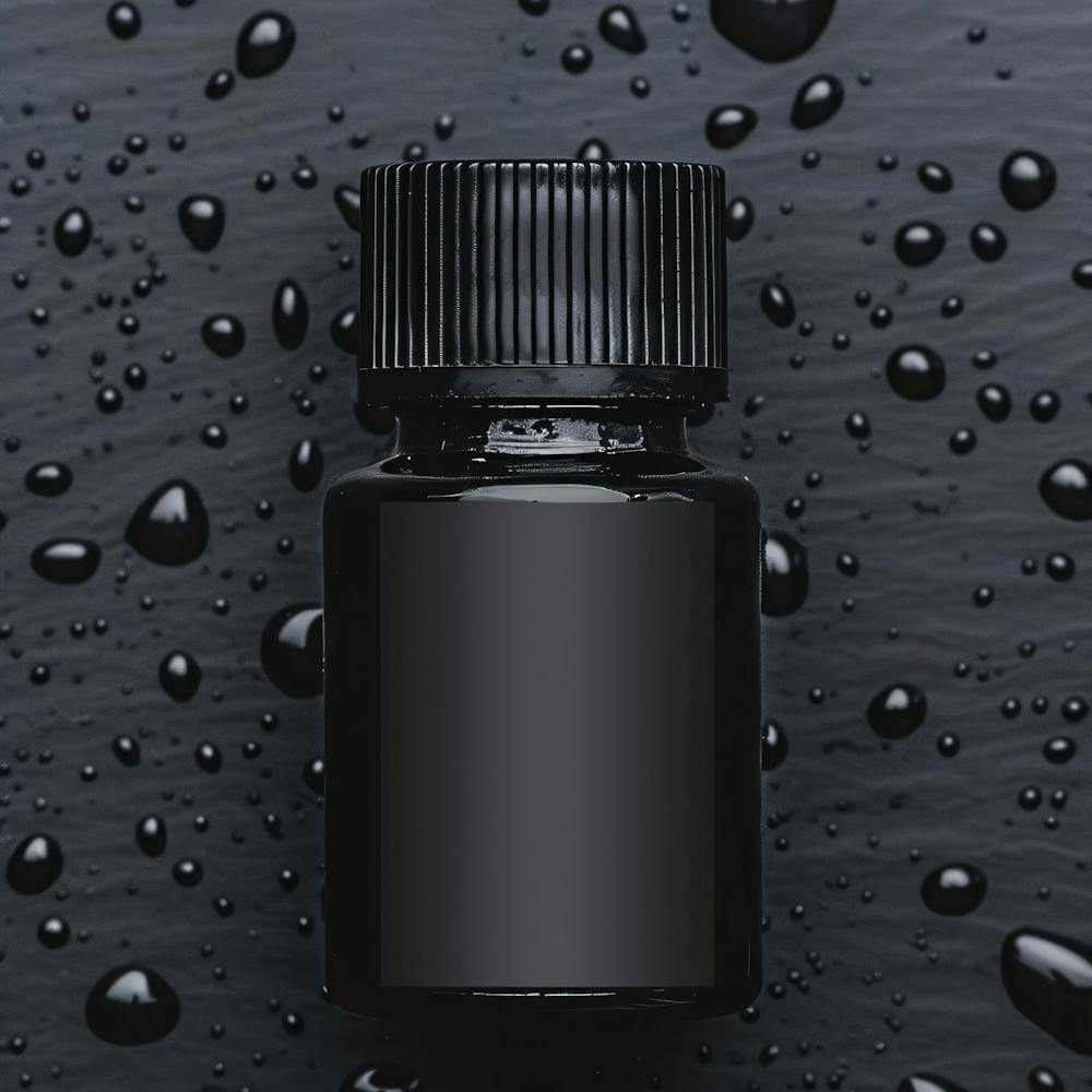 Black Bottle With Drops Of Water