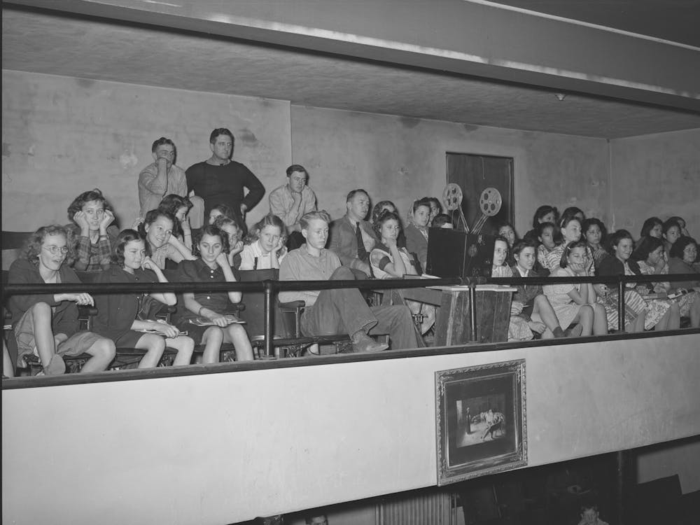 High School Students In Balcony Of School Auditorium Watching Moving Picture Which Was Part Of The