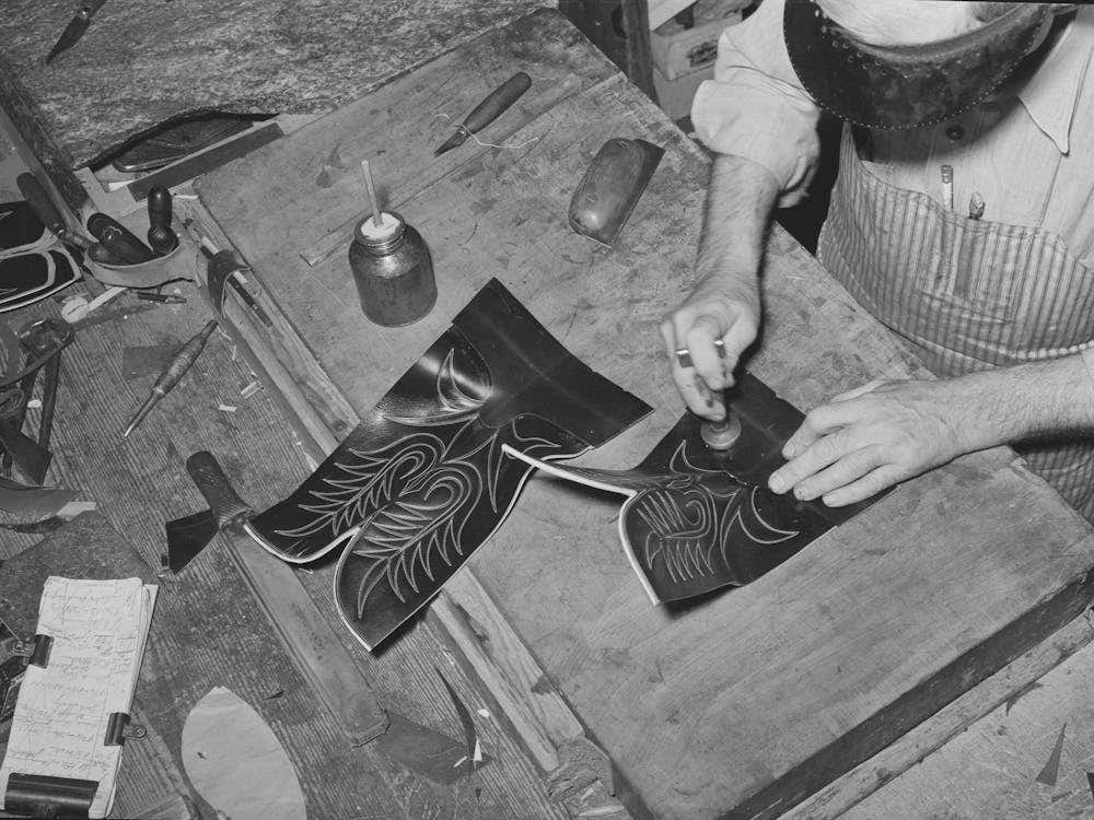 Tamping Glued Leather Together After The Heel Section Of Uppers Has Been Attached To Stitched Section Of Boot