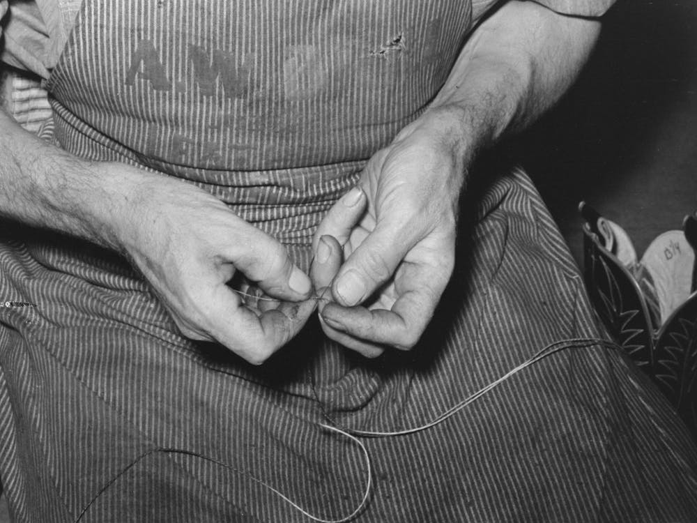 Threading A Needle With Waxed Thread, Bootmaking Shop, Alpine, Texas By Russell Lee