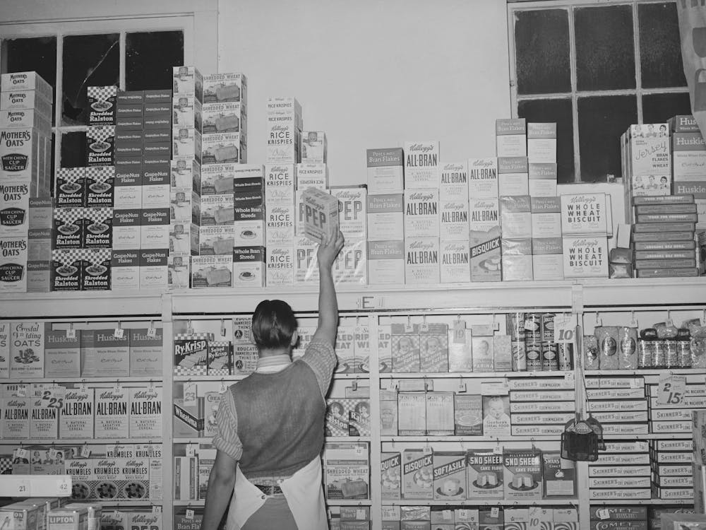 Placing Packaged Goods On Display Rack, Retail Grocery, San Angelo, Texas By Russell Lee