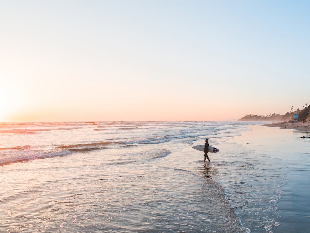 Surf Girl On Beach At Sunset