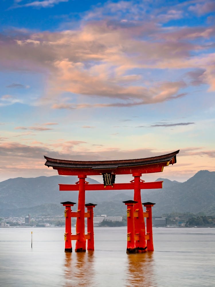 Torii Of Itsukushima Shrine On Miyajima In The Evening