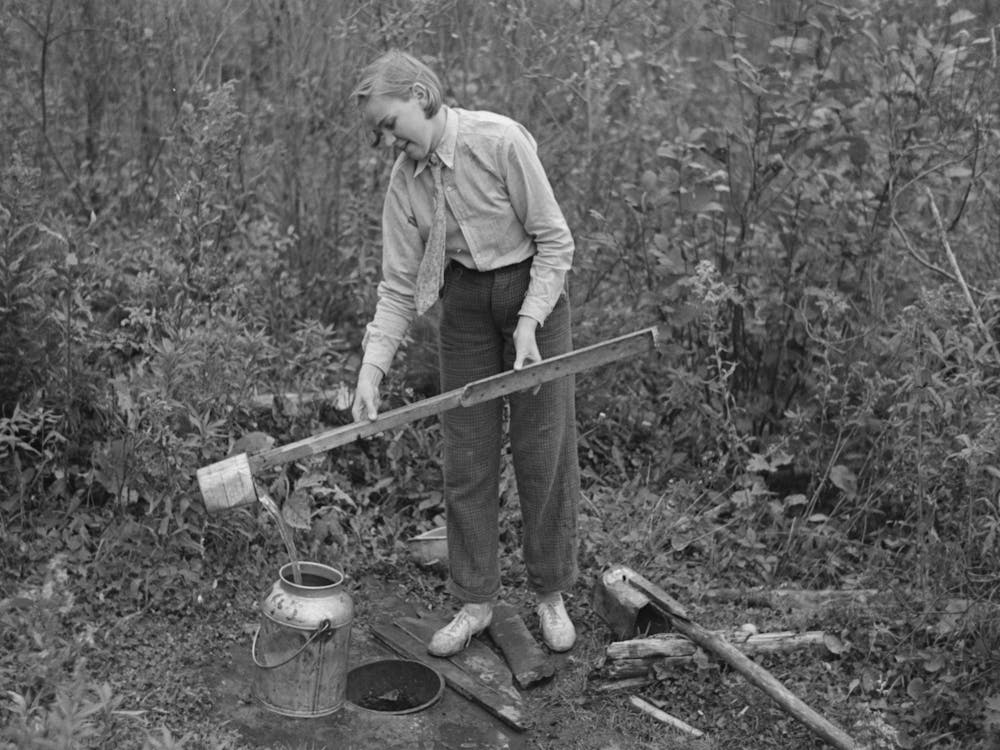 Filling Can With Water From Shallow Well On Farm Near Northome, Minnesota By Russell Lee