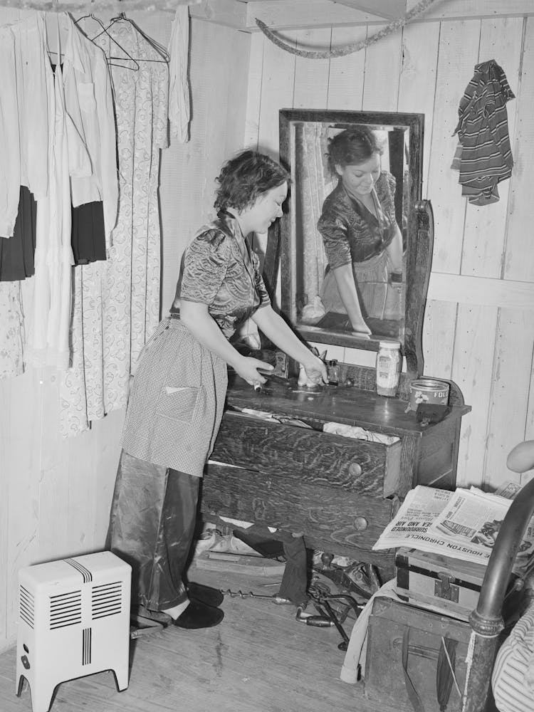 Daughter Of Carpenter From Hobbs, New Mexico, Straightening Dresser In Room In Tourist Court Which Is Now The Family