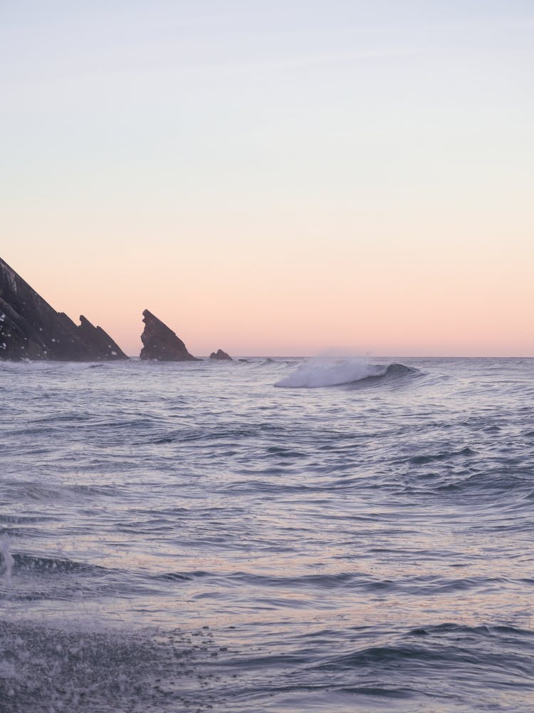 Pastel sunrise at Praia da Adraga in Portugal - beach, sea, ocean and peace - nature and travel photography by Christa Stroo