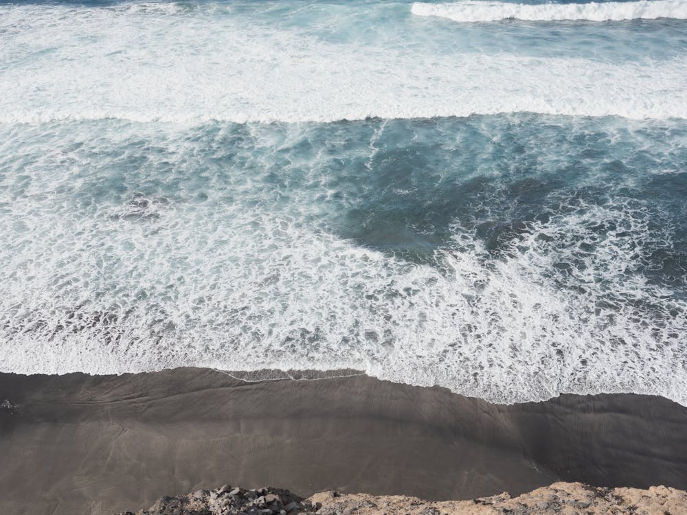 Coastal Contrast Black Sand And Turquoise Waters