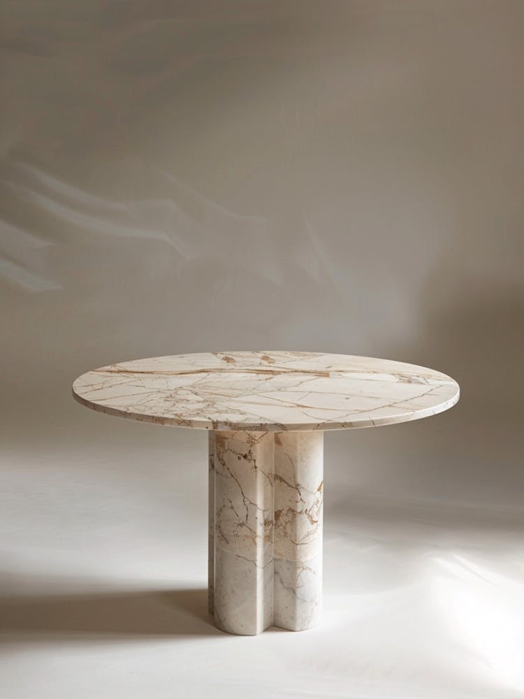 Marble Table, Circular Top With A Small Relief Pattern On The Edge Of The Tabletop, Cream Colored Marble, High End Feel, Minimalist Style, Standing In Front Of It Is An Ailin Meite Logo In The Style Of Product Photography, Front View