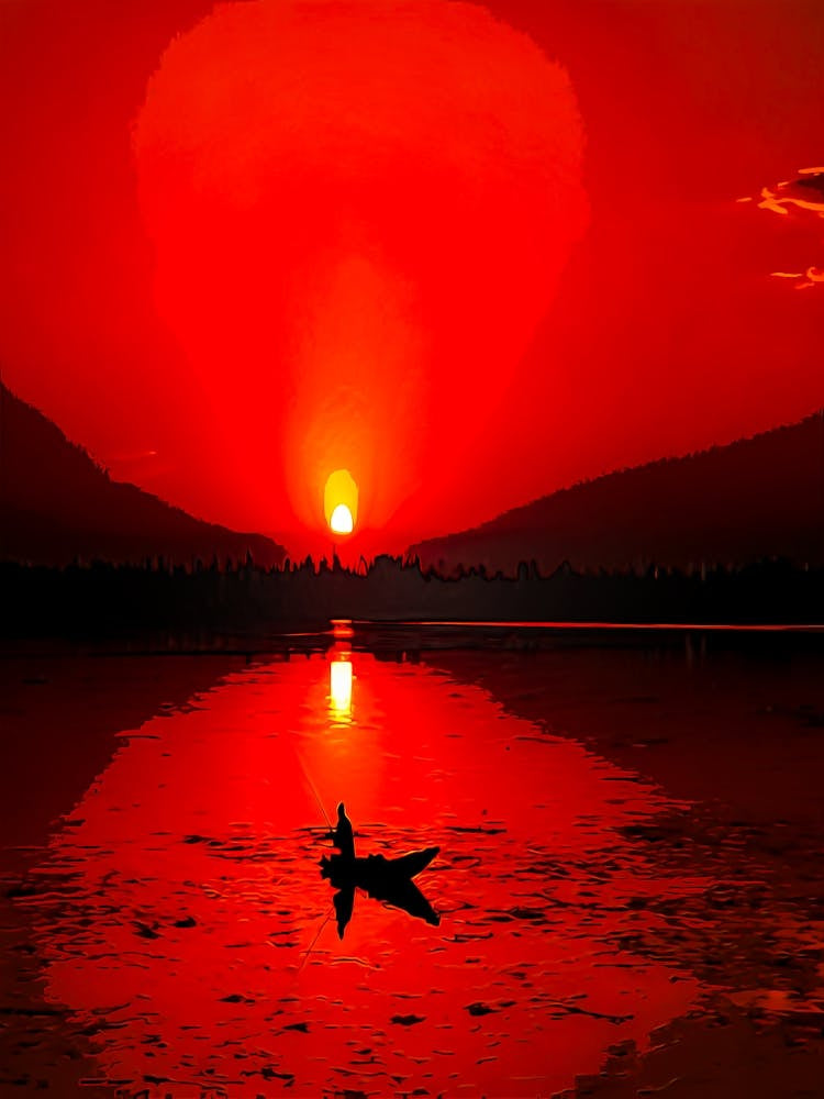 A Man Sits On His Boat While Fishing During Sunset At Dal Lake In Srinagar On June 16, 2020