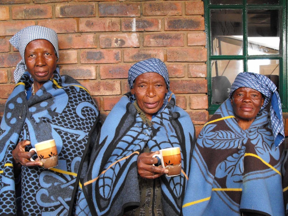 Three Women Holding Cups Of Coffee