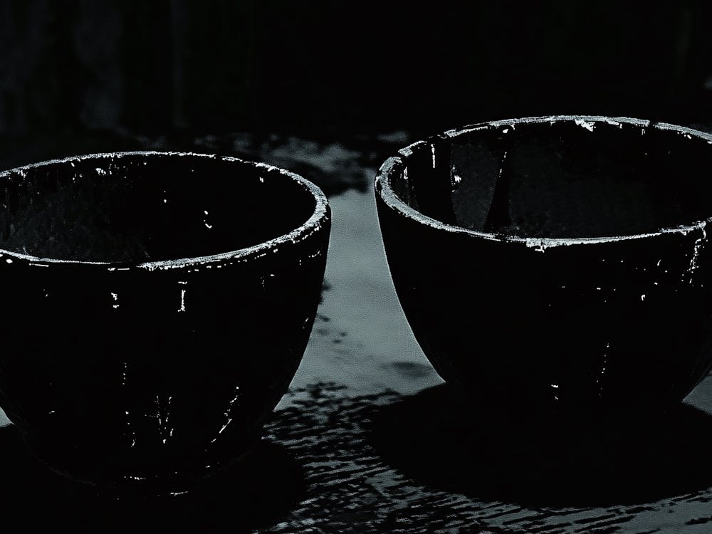 Two Black Cups On A Table