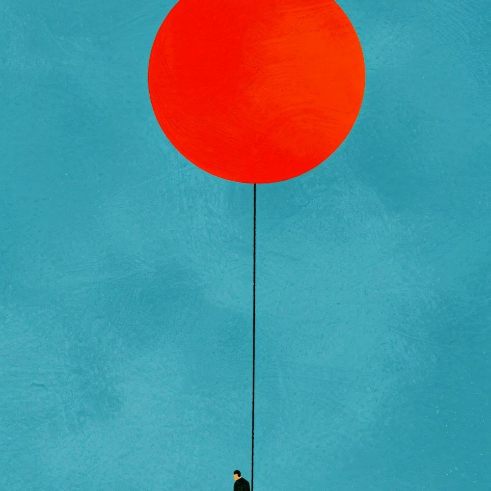 Man Holding A Red Balloon