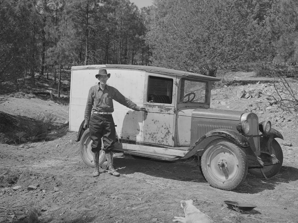 Eugene Davis Standing By The Side Of His Adapted Truck Which Carries Him About The Country On His Search For Gold