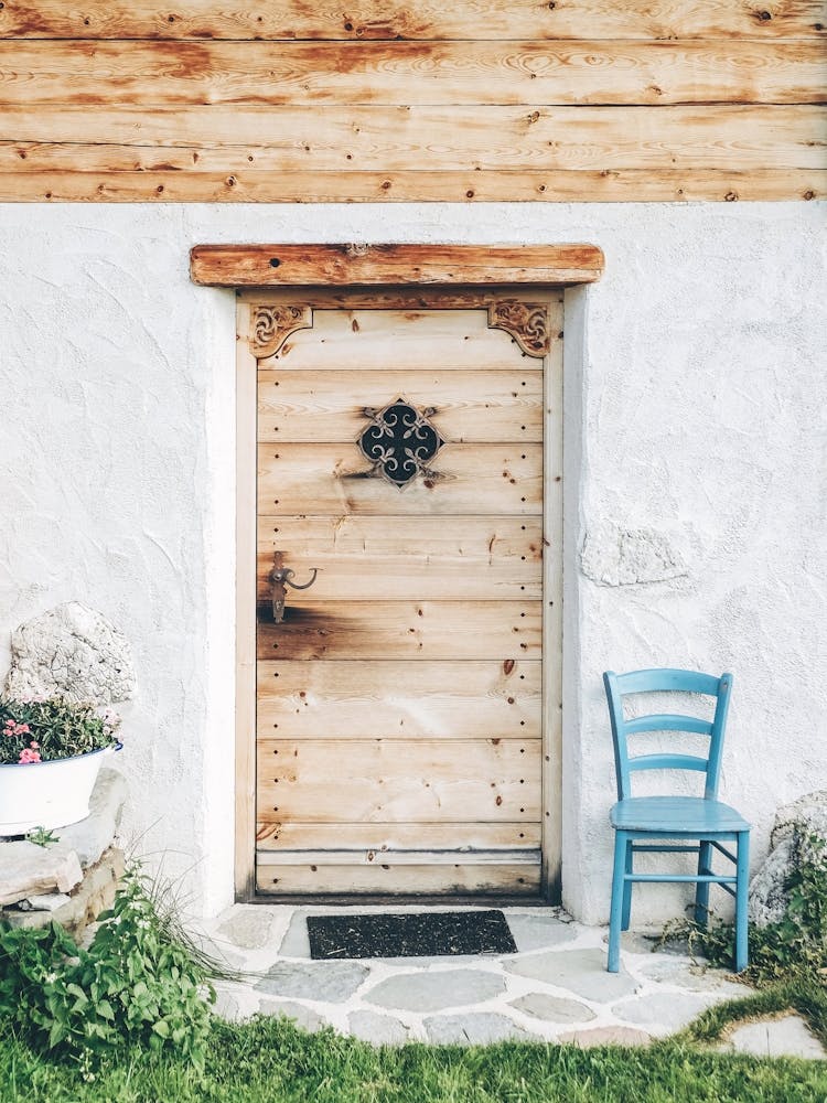 Dolomites, Italy I Wood door from a mountain chalet to the authentic rustic charm of a farmhouse photography in a nature Alps landscape with minimalist geometric pastel retro vintage aesthetic architecture