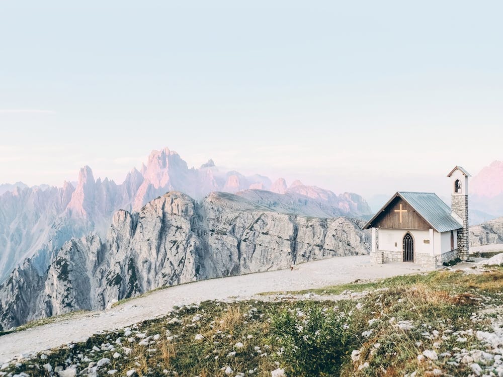 Dolomites, Italy I Alpes mountain landscape photography and a church lost in the Tre Cime di Lavaredo at sunrise surrounded by majestic mountains and boho bohemian wilderness nature with pastel aesthetic