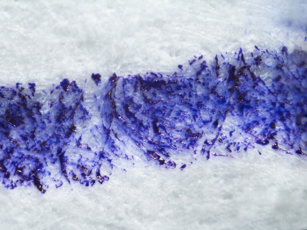 Dripping Blue Ink On Paper Under The Microscope