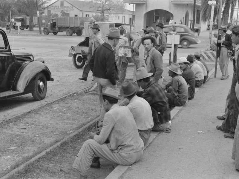 Men Sitting Along Railroad Platform Waiting For Work As Day Laborers, Raymondville, Texas By Russell Lee