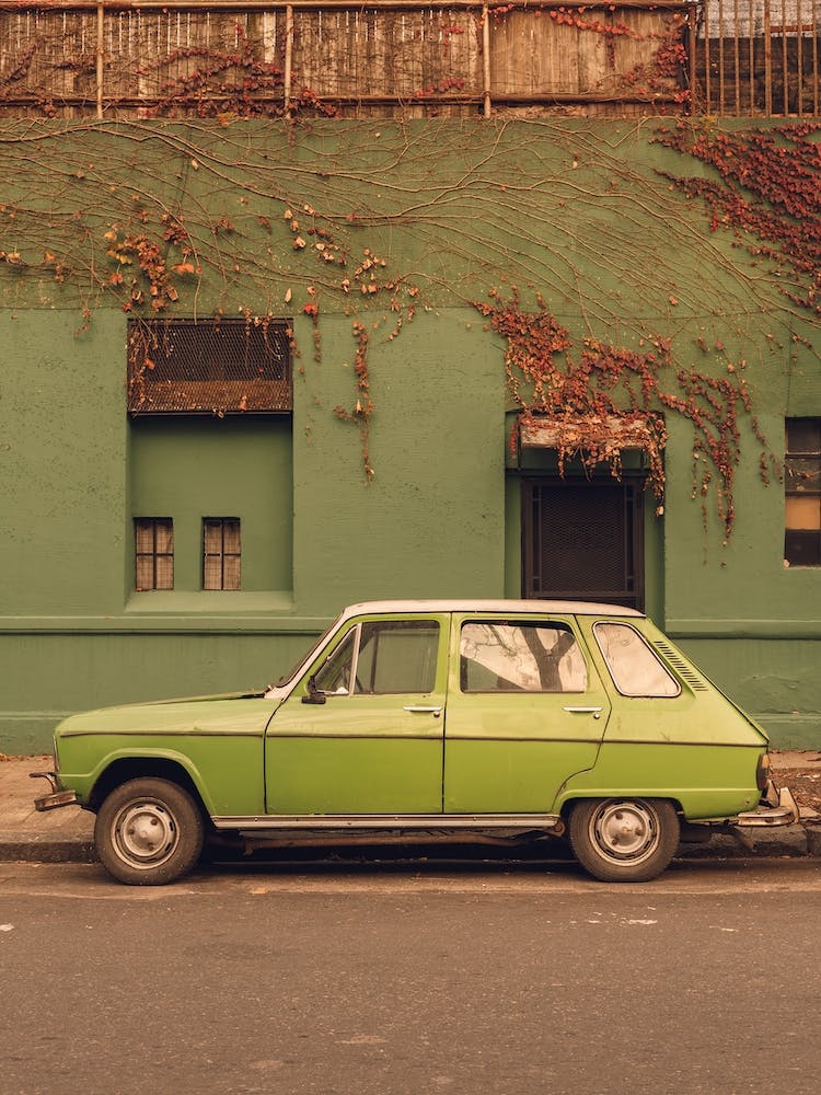 Old Green Car With Green Wall Behind