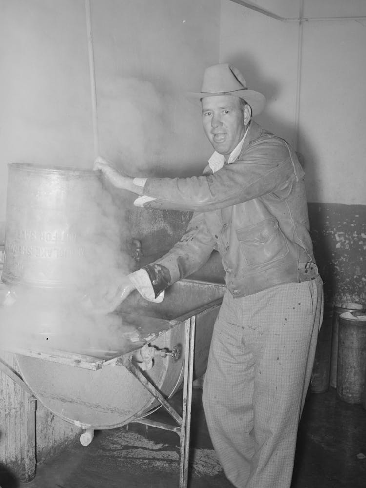 Farmer steaming his milk cans before taking them home, Creamery, San Angelo, Texas by Russell Lee
