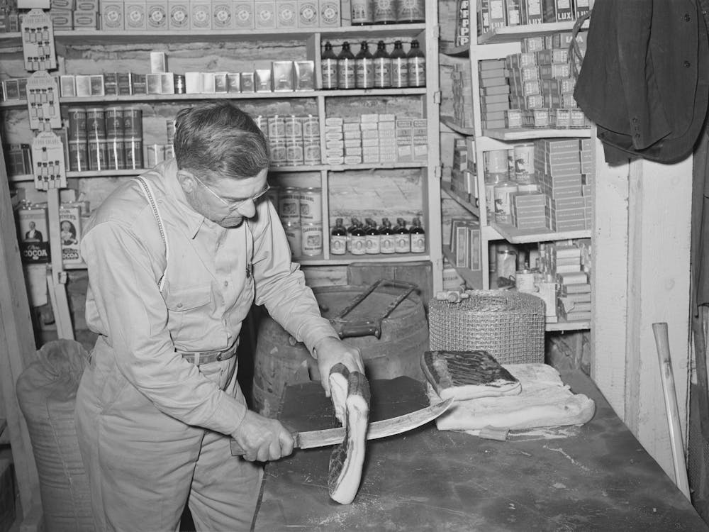 Mr, Keele Slicing Bacon In The General Store At Pie Town, New Mexico By Russell Lee