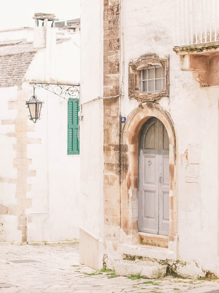 Puglia, Italy I Deserted street with Italian Baroque architecture and vintage retro door photography in damaged condition with summer pastel aesthetic of la dolce vita in a countryside village in south