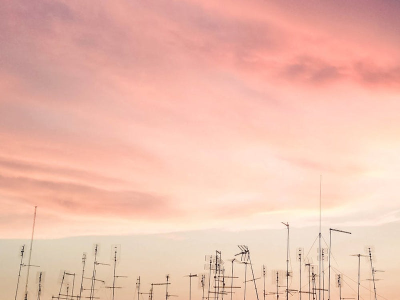 Rome, Italy I Rooftop antennas at sunset under stormy pink pastel sky with minimalist geometric urban pattern architecture photography in soft summer evening light over the city for la dolce vita