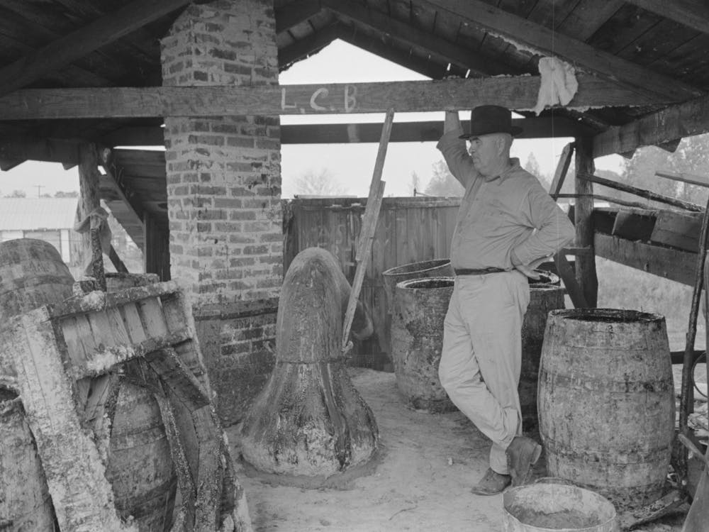 Owner Atop His Turpentine Still, Goosneck Runs From The Still To The Condenser Coils Where Vapors Are