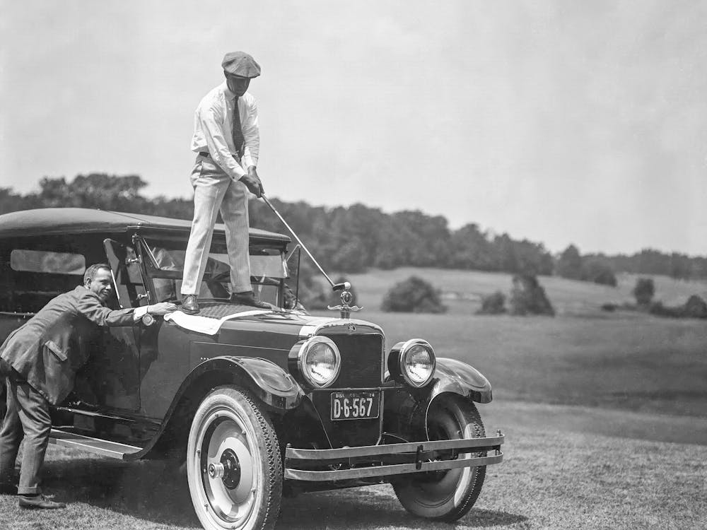 Golfer Teeing Off On Top Of A Car, Vintage Golf Art, Black and White Old Photo