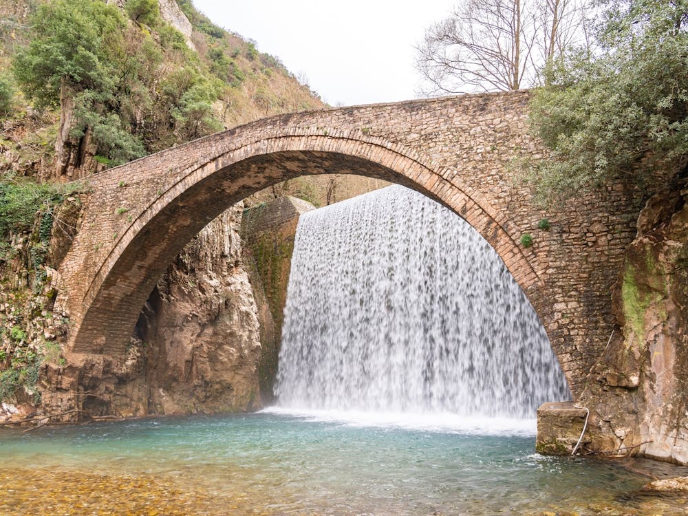 Arch Bridge Over Waterfall
