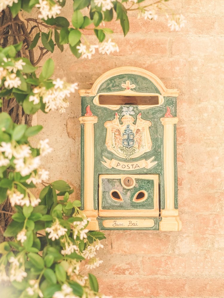 Tuscany, Italy I Italian ceramic mailbox in Pienza with star jasmine on rustic stone wall in vintage countryside photography with Mediterranean pastel aesthetic, poetic dolce vita Italian summer vibes