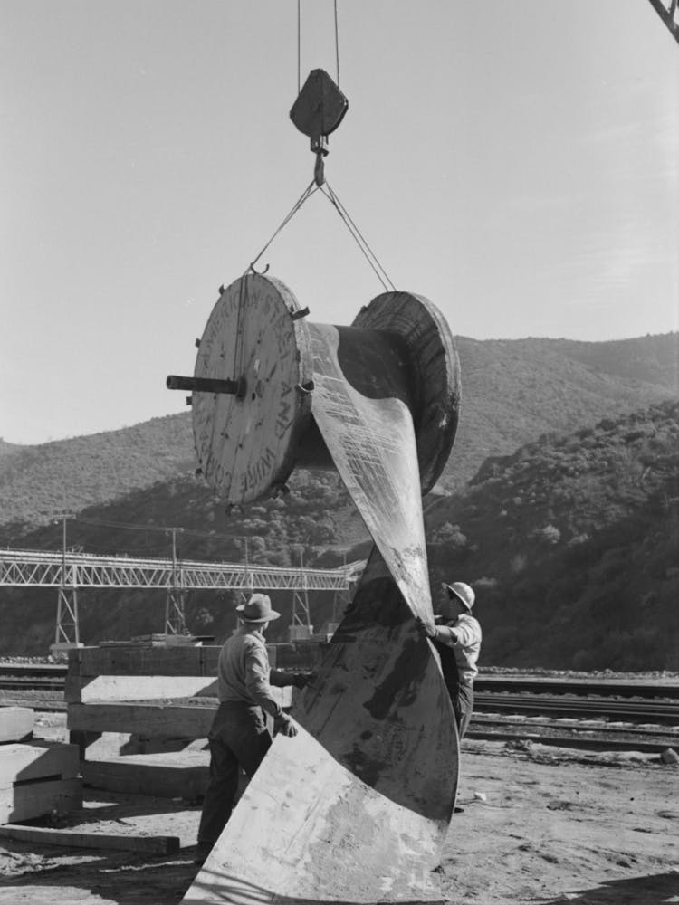 Workmen Handling Section Of Rubber Conveyor Belt Which Transports Gravel To Shasta Dam, Shasta County, California