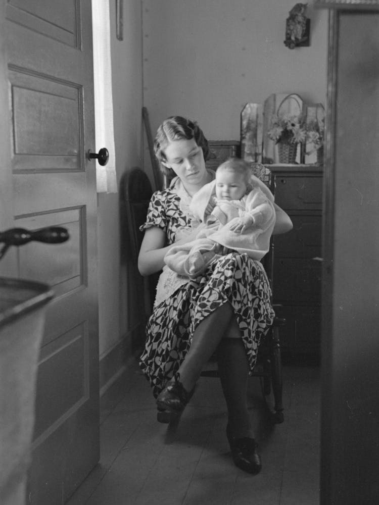 Untitled Photo, Possibly Related To Child On Lap Of Mother Reading The Newspaper, Nissen Shack Near Dickens