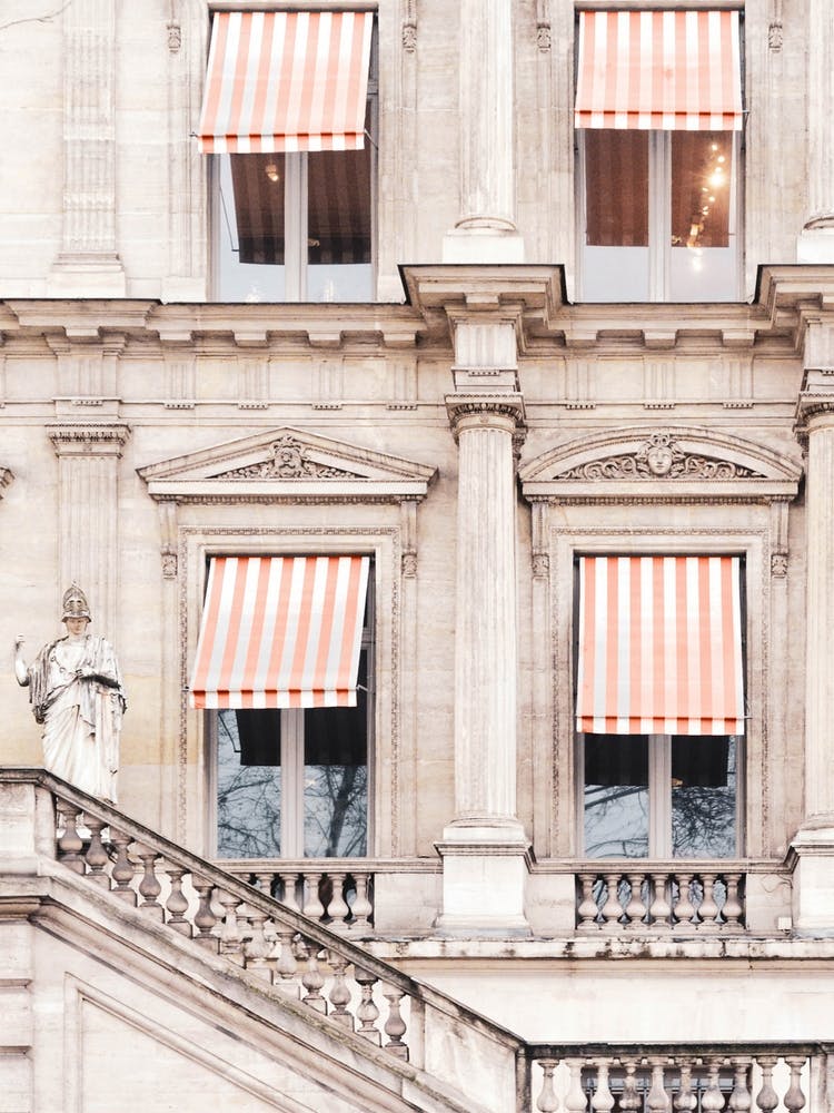Paris Building With Orange And White Striped Awnings