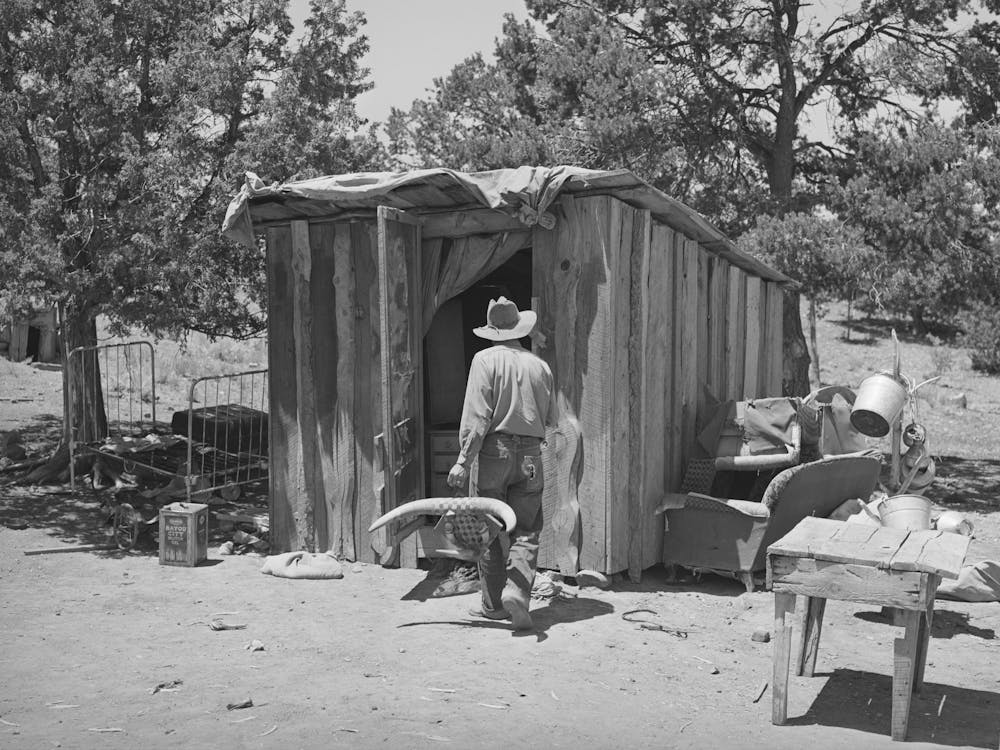 Faro Caudill Taking Household Articles Into Shed For Storage While He Moves His Dugout, Pie Town, New Mexico By