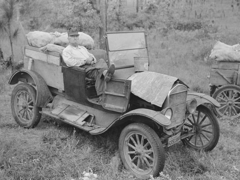 Farmer Sitting In Broken Down Ford Truck Waiting For Garageman Near Amite, Louisiana By Russell Lee