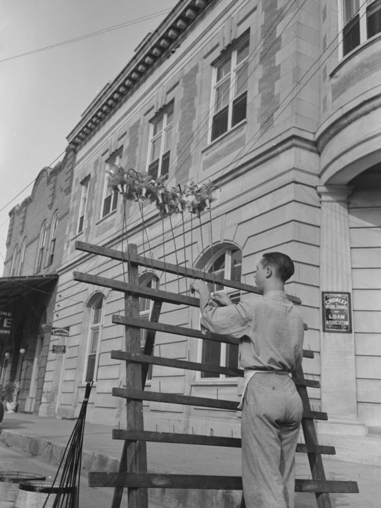 Untitled Photo, Possibly Related To Concessionaire Placing Doll Canes In Rack, National Rice Festival, Crowley