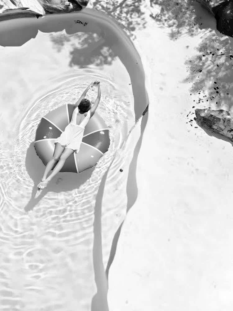 Woman Floating In A Pool