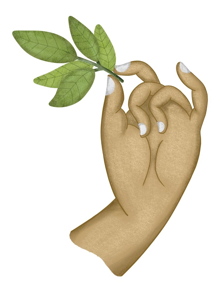 Delicate goddess hand holding green leaves