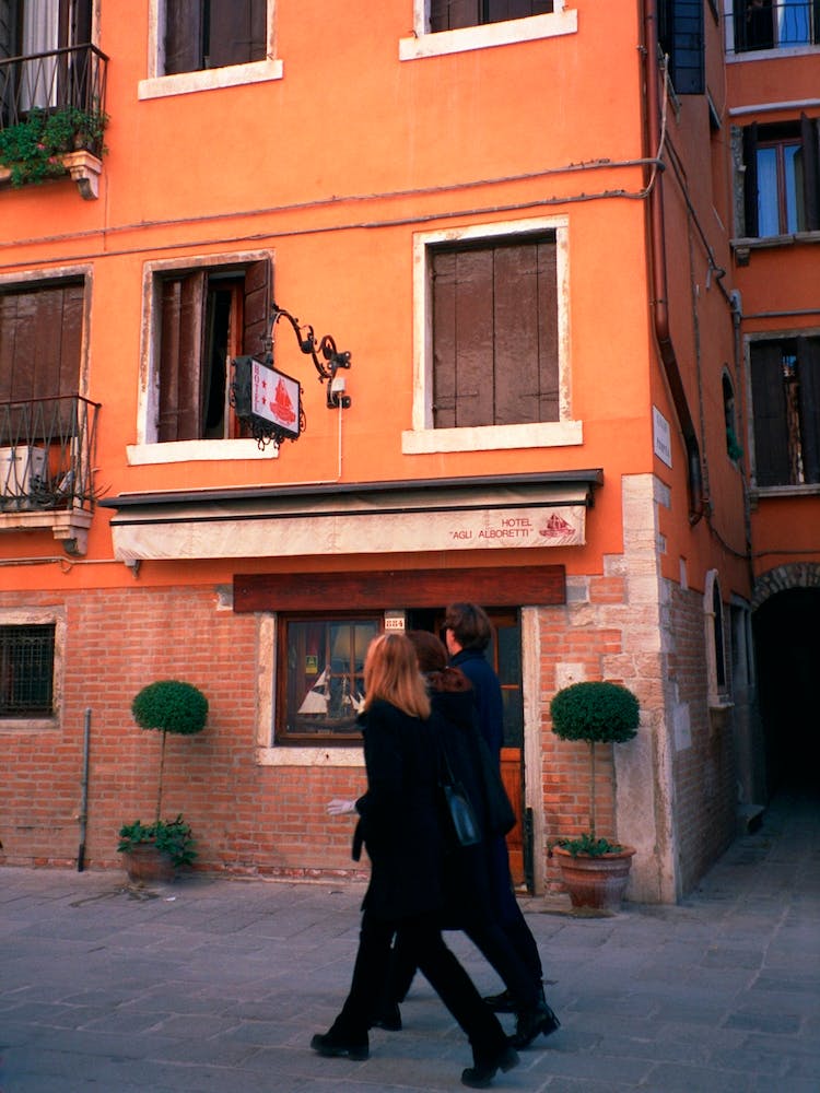 Walking Past A Terracotta Albergo Venice Italy