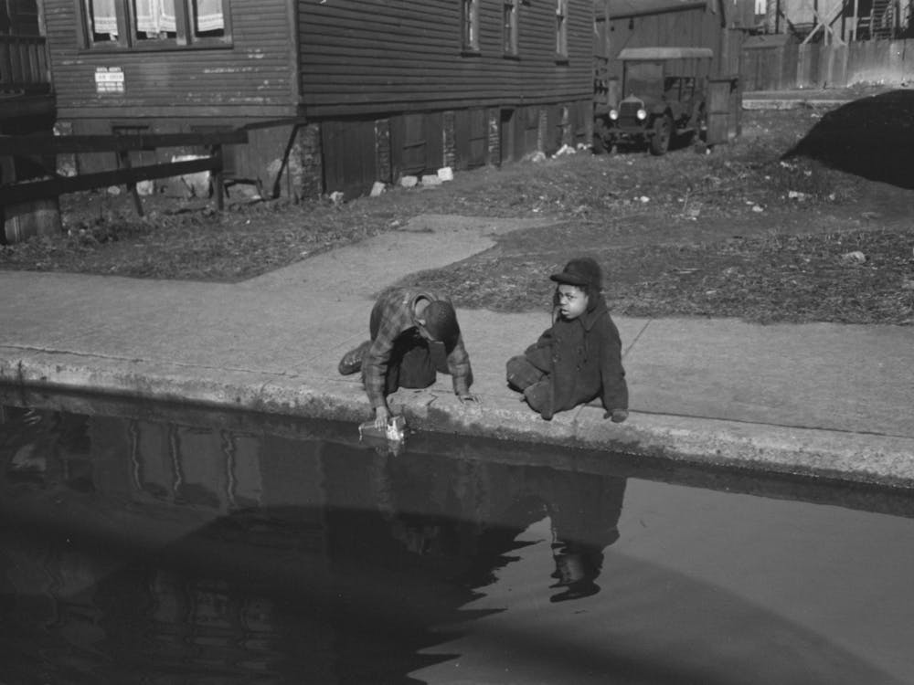 Children Playing In Water Backed Up In Gutter, South Side Of Chicago, Illinois By Russell Lee