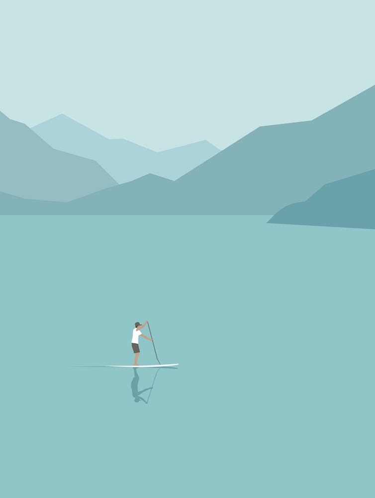 Paddle boarding in scenic landscape