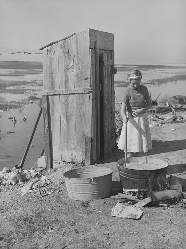 Daughter Of Roofer Washing Clothes In Front Of Family S Tent Home, Corpus Christi, Texas By Russell Lee