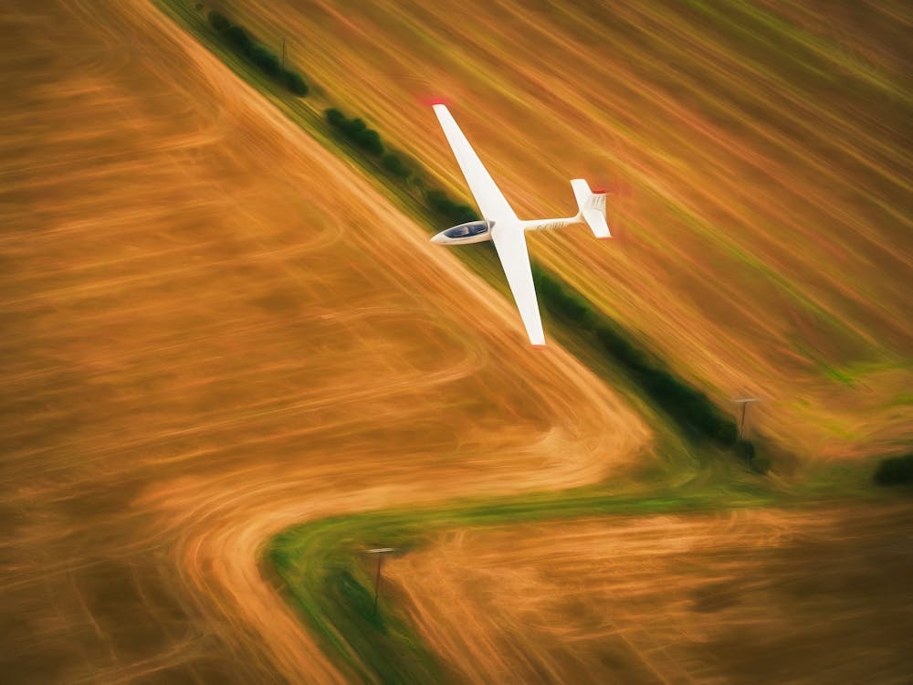 Glider Flies Over Fields