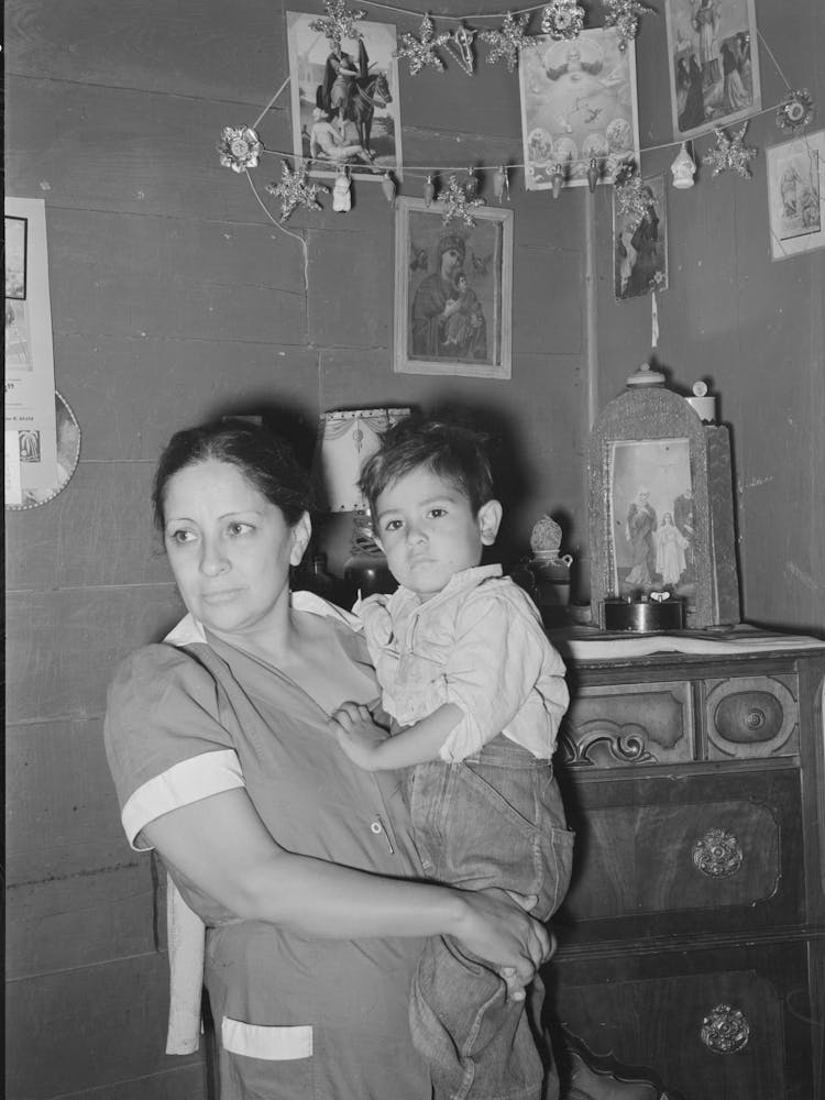 Mexican Mother And Child In Front Of Shrine In Corner Of Room, San Antonio, Texas By Russell Lee