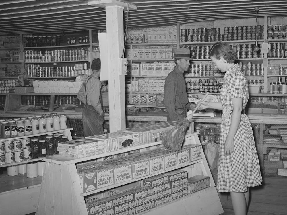Clerk In General Store Dusting, Pie Town, New Mexico By Russell Lee