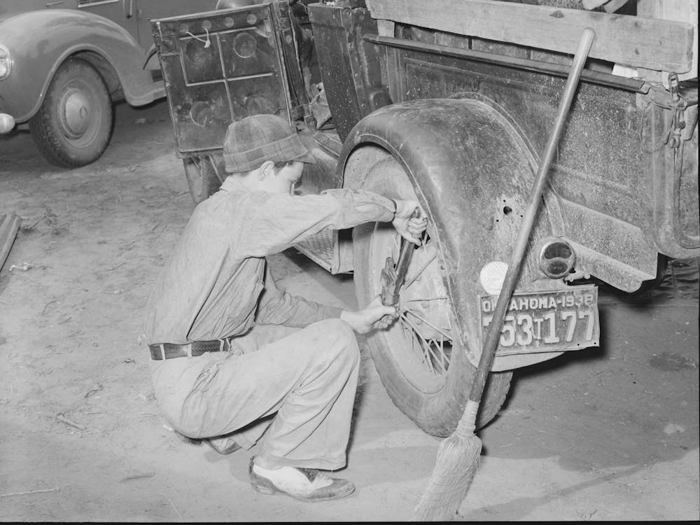 Tightening The Rear Wheel On Truck Which Will Carry Migrant Family To California From Muskogee, Oklahoma By Russell